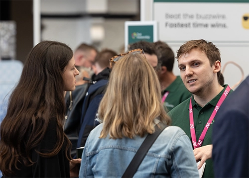 josh hancock talking to women at a conference