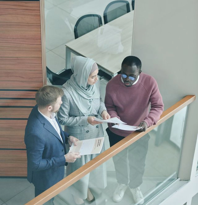 three people talking in an office