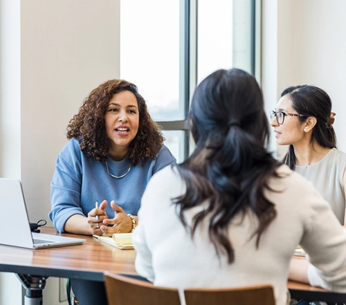 three women work meeting